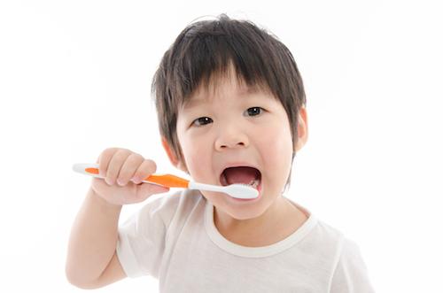 Toddler brushing his teeth at dentist in Springfield IL