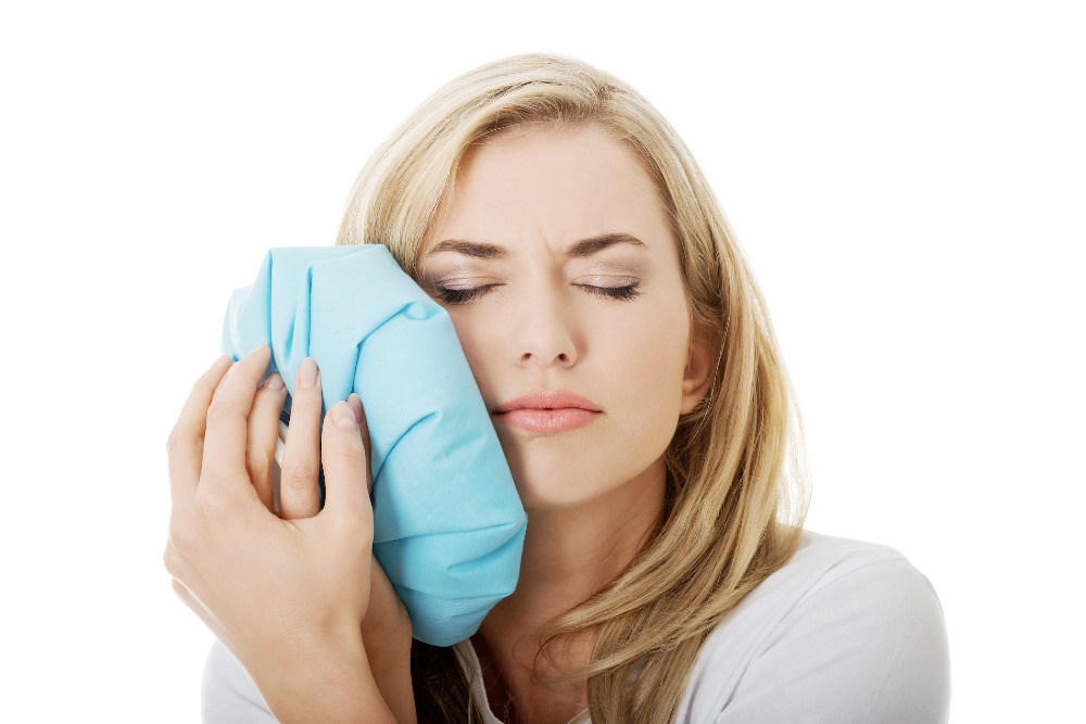 Woman icing her face after a tooth extraction near Springfield IL