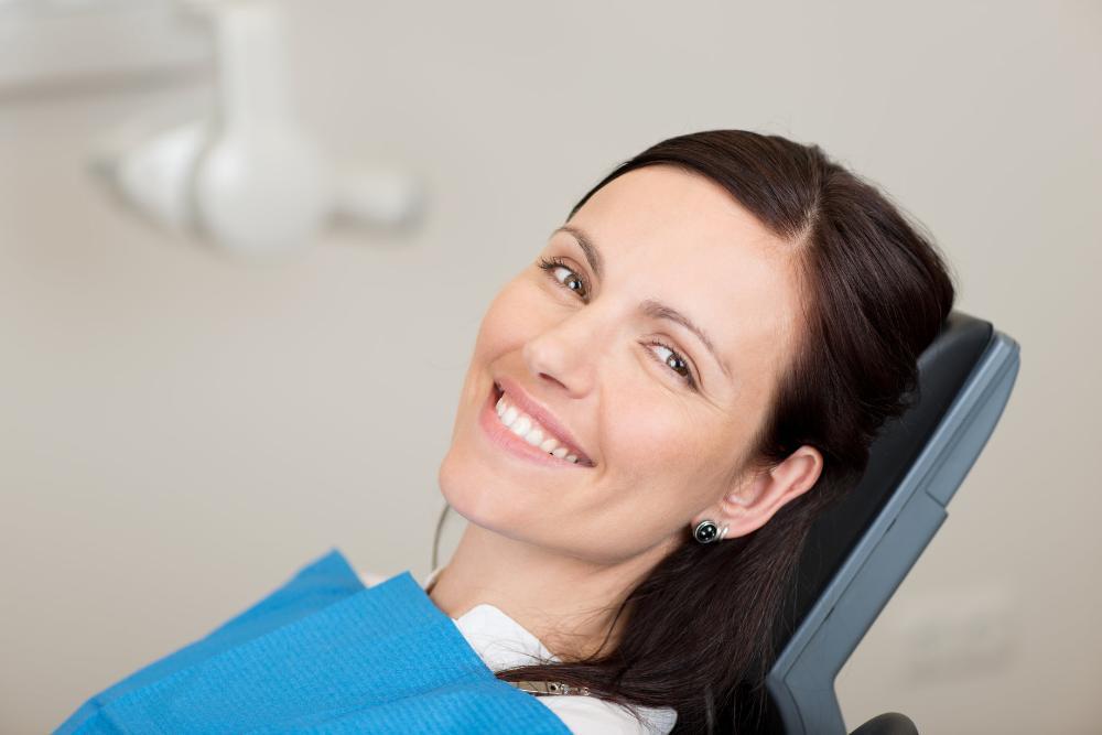 woman smiling in dental chair after dental cleaning in Springfield, IL