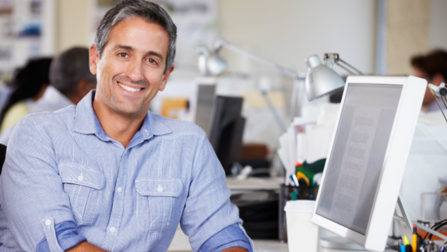 man sitting next to computer | dental extractions springfield il