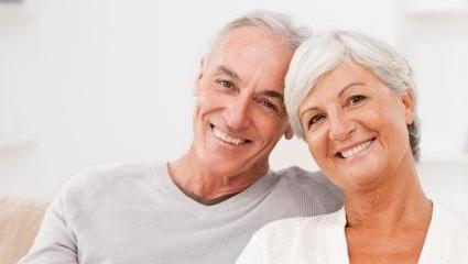 Husband and wife sitting on couch at Springfield IL Dentist office