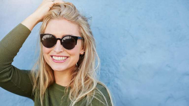 woman with glasses smiling