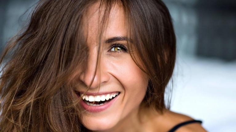 Woman smiling at dentist office in Springfield IL