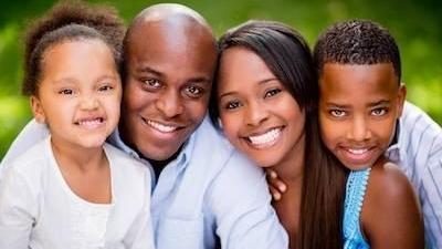 family of four smiling | dentist springfield il