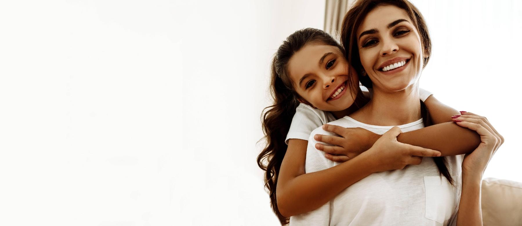 Mother and daughter smiling at family dentist office in Springfield IL